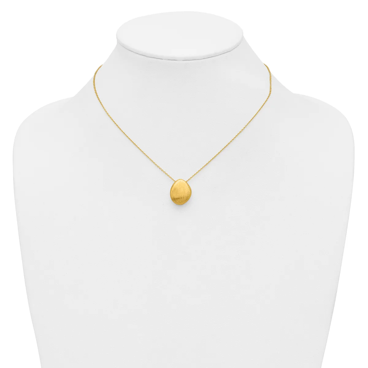A gold chain necklace with a small brushed gold oval pendant displayed on a white mannequin bust.