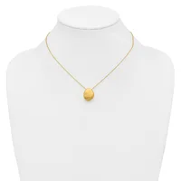 A gold chain necklace with a small brushed gold oval pendant displayed on a white mannequin bust.