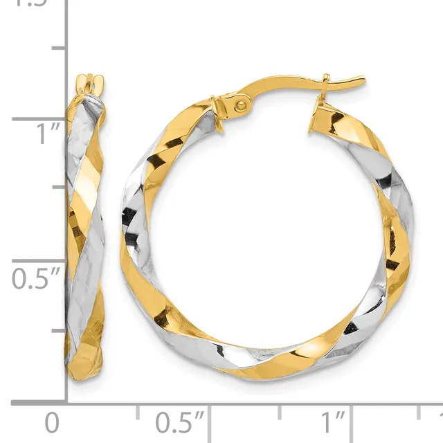 Two-tone twisted hoop earrings with gold and silver sections, shown next to a measurement scale indicating approximately one inch in diameter.