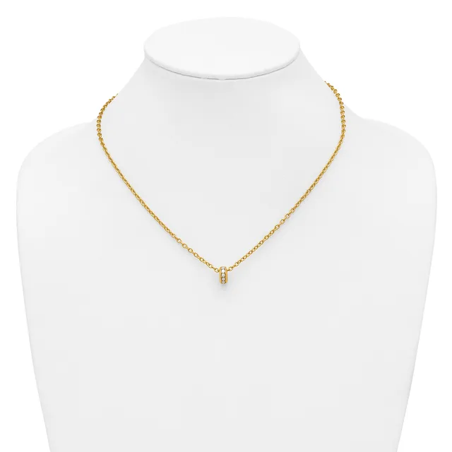Gold-toned chain necklace with a small pendant featuring what appears to be a small diamond or gemstone, displayed on a white mannequin bust.