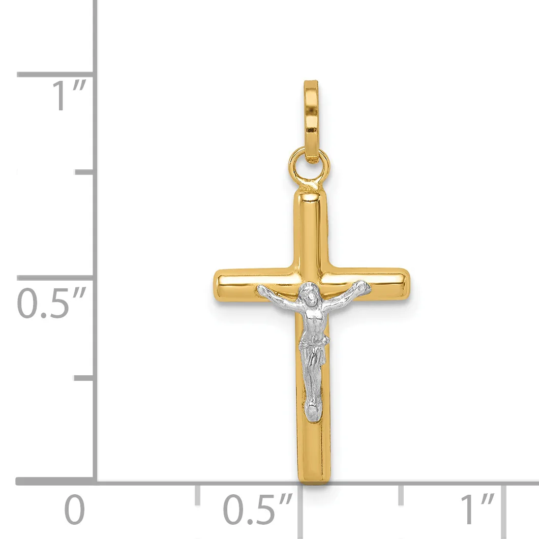 A two-tone gold crucifix pendant with a polished yellow gold cross and a white gold corpus figure, displayed against a measurement scale showing approximately one inch in height.