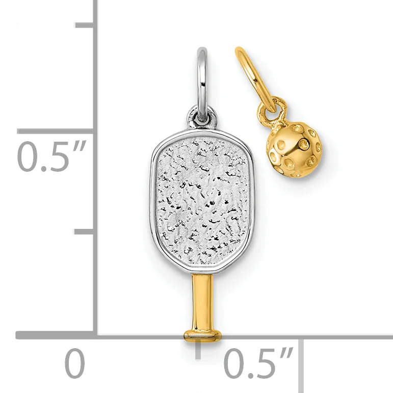 Two silver and gold paddle-shaped charms with textured surfaces displayed against a measurement scale showing approximately half an inch in height.