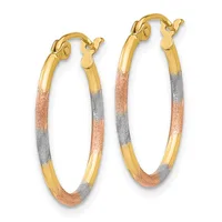 A pair of gold hoop earrings with textured sections in rose and white gold, featuring gold lever-back closures.