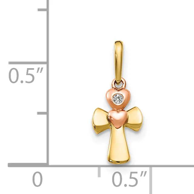 A two-tone gold cross pendant with a rose gold heart featuring a bezel-set diamond displayed next to a ruler showing approximately half-inch dimensions.