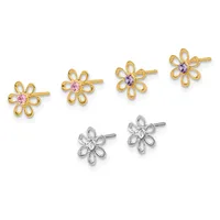Six flower-shaped stud earrings arranged in two rows: four gold earrings with pink and purple gemstone centers in the top row, and two silver earrings with clear gemstone centers in the bottom row.