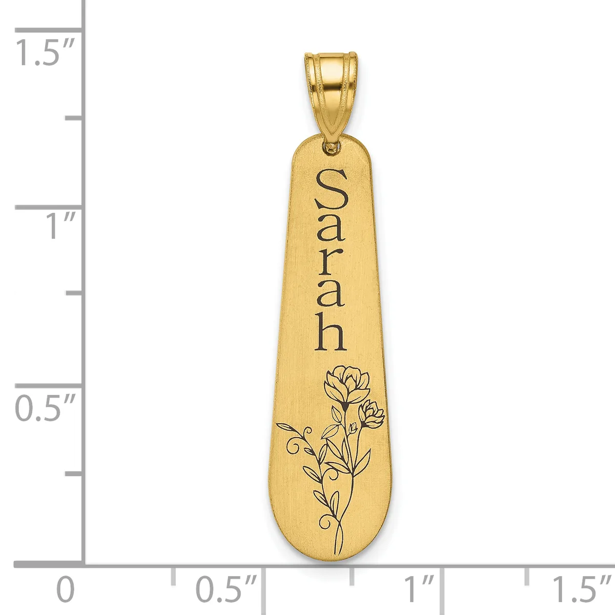 Gold-toned elongated pendant with "Sarah" engraved vertically and a floral design at the bottom, shown against a measurement scale.