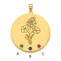 Gold circular pendant with an engraved floral design and three gemstones positioned at the bottom, shown with a gold bail at the top.