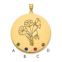 Gold circular pendant with an engraved flower design and four colored gemstones positioned at cardinal points, shown with a bail loop at top.