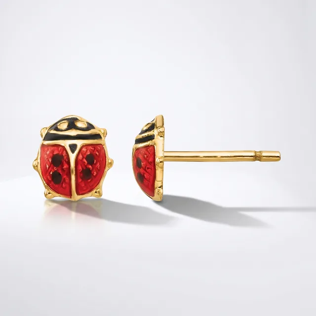 A pair of gold stud earrings shaped like red and black ladybugs with gold posts and backs, shown from front and side views.