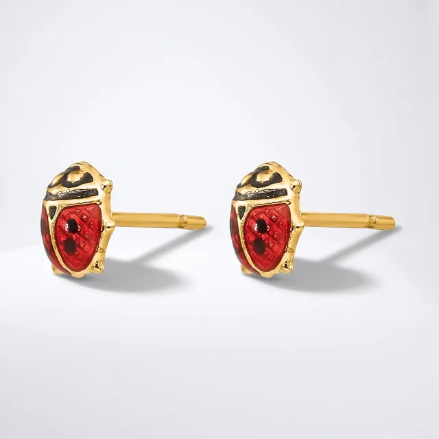A pair of gold stud earrings with red enamel ladybug designs, featuring black spots and gold-tone metal settings, shown against a white background.