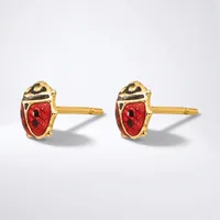 A pair of gold stud earrings with red enamel ladybug designs, featuring black spots and gold-tone metal settings, shown against a white background.