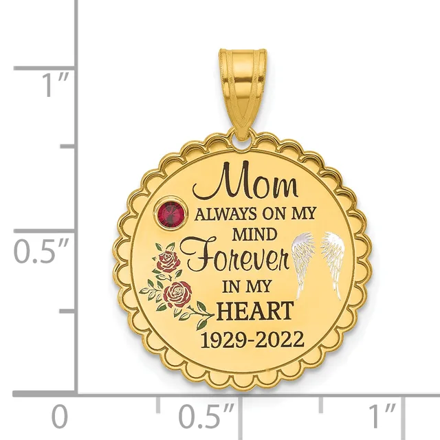 Gold-colored round pendant with scalloped edges, engraved text reading "Mom Always On My Mind Forever In My Heart 1929-2022," decorative roses, a red gemstone, and white angel wings, shown next to a measurement scale.