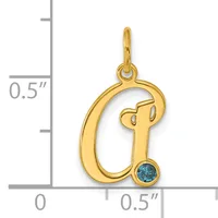 Gold-colored letter Q charm with a small blue gemstone at the bottom, shown next to a ruler indicating approximately half an inch in height.