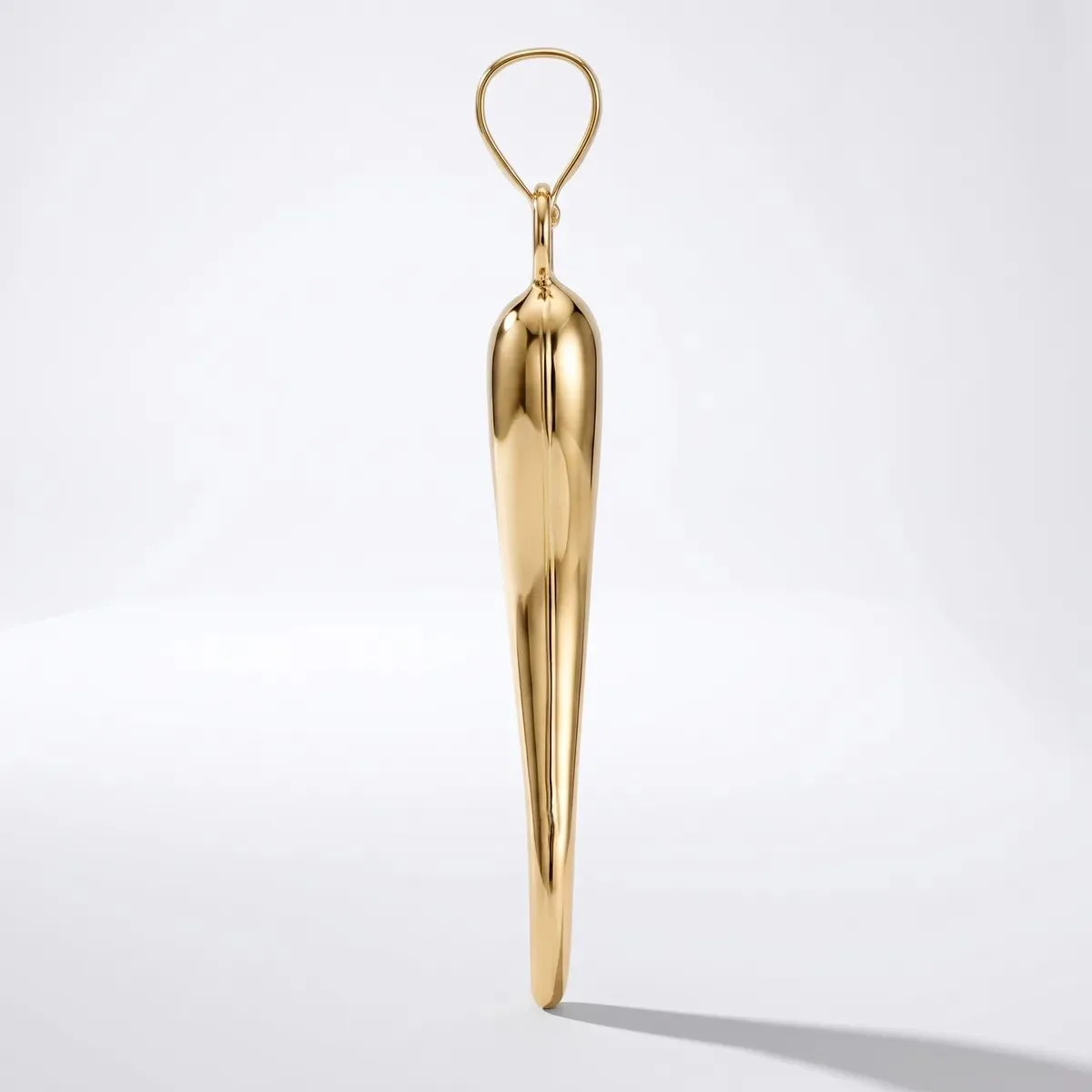 A polished brass pendant in an elongated teardrop shape with a looped bail at the top, photographed against a white background.