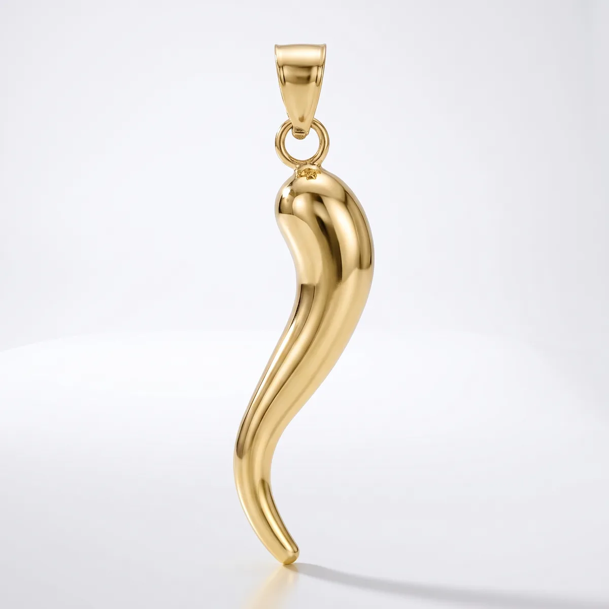 A polished gold curved horn-shaped pendant with a small rectangular bail loop at the top, suspended against a white background.