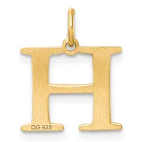 Gold letter H pendant with a polished bail at the top and a small stamped hallmark on the lower left side.