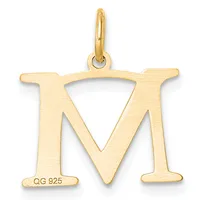 Gold letter M pendant with a triangular cutout in the center and a small stamped hallmark on the lower left, suspended from a gold bail.