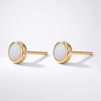 A pair of gold stud earrings with oval opals set in round bezels, shown from the front against a white background.