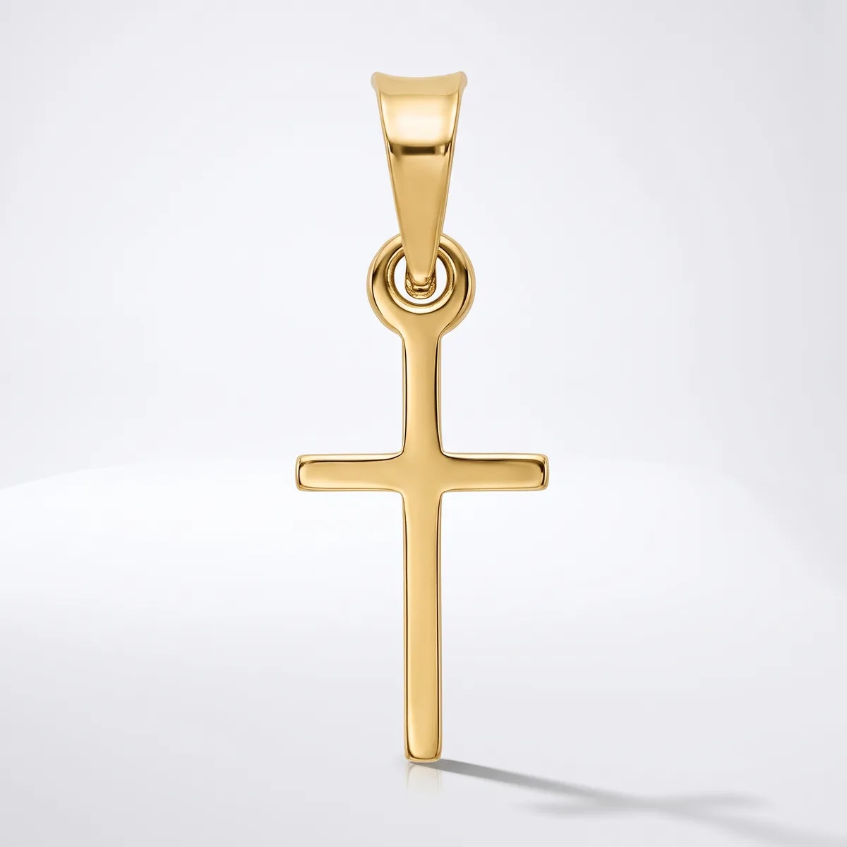A polished gold cross pendant with a rectangular bail loop at the top, displayed against a white background.
