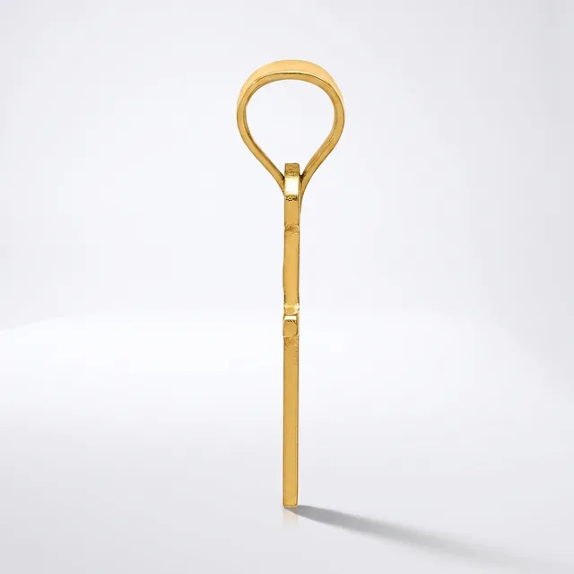 A gold-toned metal teaspoon with a long handle and a loop-shaped bowl end, displayed vertically against a white background.