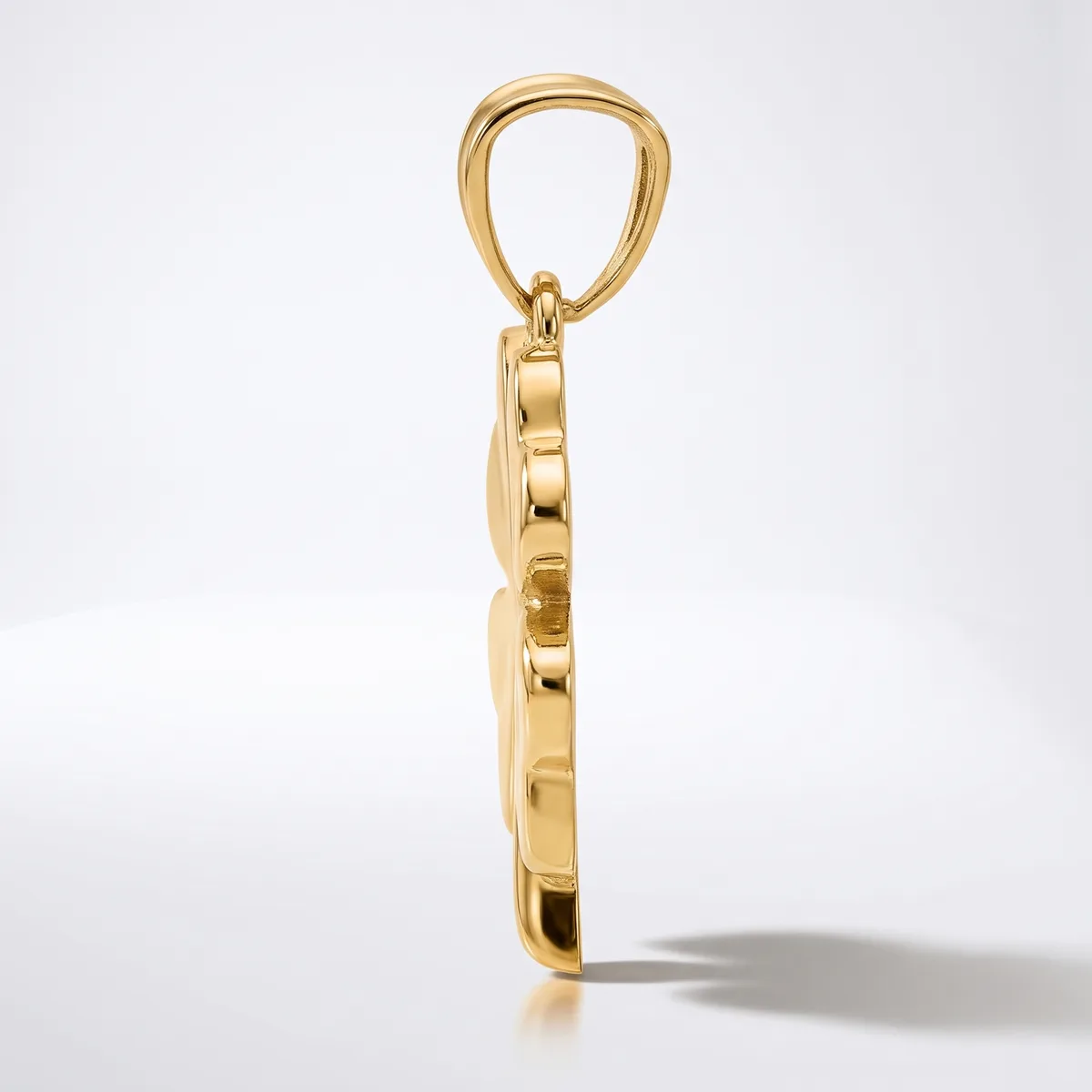 A polished gold pendant charm featuring a rectangular stone or crystal frame suspended from a bail loop, shown against a white background.