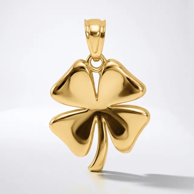 A polished gold four-leaf clover pendant with a curved stem, shown suspended against a white background.