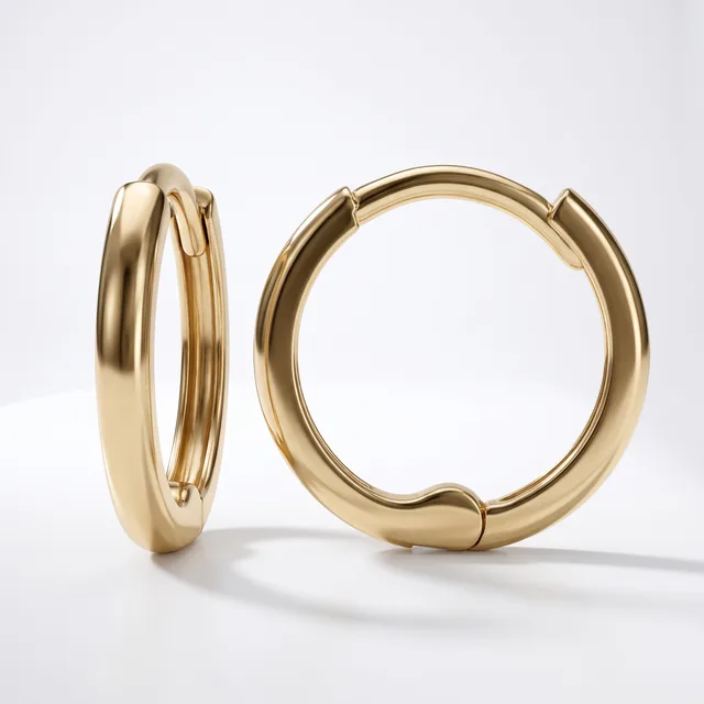 A pair of polished gold hoop earrings with a chunky, rounded profile and hinged closure, displayed against a white background.