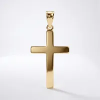 A polished gold cross pendant with a rectangular bail loop at the top, displayed against a white background with a soft shadow beneath it.