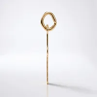 A gold-toned metal hair stick with a decorative loop handle at the top and fine textured detailing along the shaft, displayed vertically against a white background.