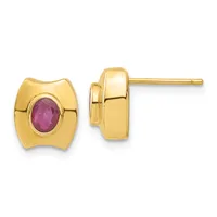 A pair of gold stud earrings with curved rectangular faces, each centering an oval faceted ruby stone in a bezel setting, shown from front and side views.