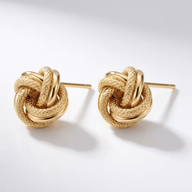 A pair of gold-toned knot stud earrings with a textured finish, displayed against a white background.