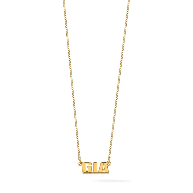 Gold necklace with a delicate chain holding a rectangular pendant with raised block letters spelling a three-letter name.