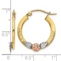 Gold hoop earrings with textured surfaces and a small rose gold flower with white gold leaves accent at the bottom, shown next to a ruler for scale.