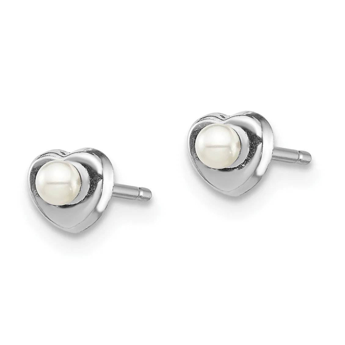 A pair of heart-shaped stud earrings in polished silver metal, each featuring a round white pearl set in the center, shown from the front against a white background.
