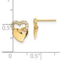 Pair of gold heart stud earrings with diamond accents along the upper curved edge and a polished solid heart below, shown on a measurement scale.
