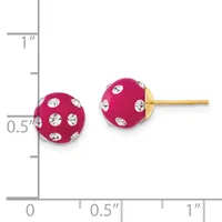 A pair of fuchsia enamel sphere stud earrings with crystal rhinestone accents and gold posts, shown next to a measurement scale.