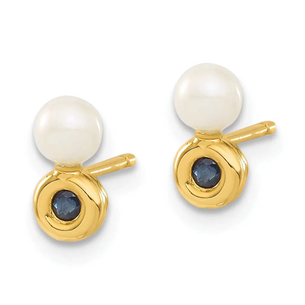 A pair of gold stud earrings, each featuring a white pearl on top and a dark blue gemstone set in a gold circular bezel below.