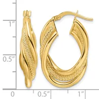 Pair of gold twisted oval hoop earrings with textured and polished surfaces, shown next to a ruler indicating approximately one inch in length.