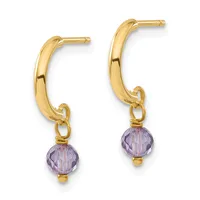 A pair of gold hoop earrings with purple faceted gemstone drops attached by small gold loops.