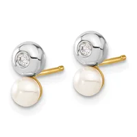 A pair of two-tone earrings featuring silver spheres set with round diamonds above dangling cream-colored pearls, displayed against a white background.