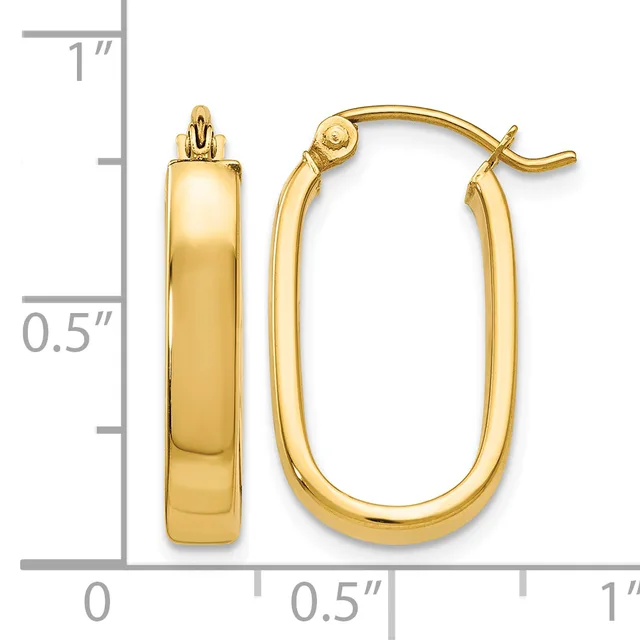 A pair of polished gold-tone oval hoop earrings with a thick, rounded profile, shown next to a measurement scale indicating approximately one inch in height.