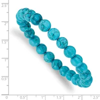 Turquoise beaded bracelet with two strands of round polished stones arranged in a curved display against a measurement scale.
