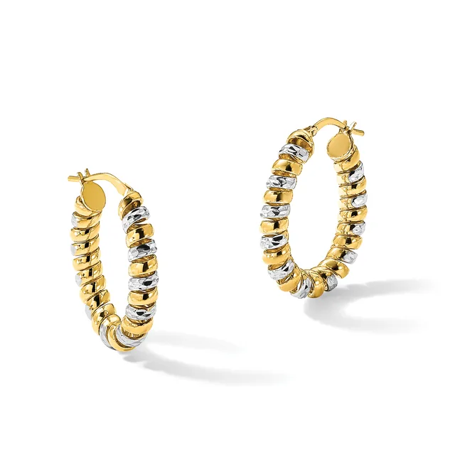 A pair of two-tone gold hoop earrings with alternating smooth and textured segments in yellow and white gold, displayed against a white background.