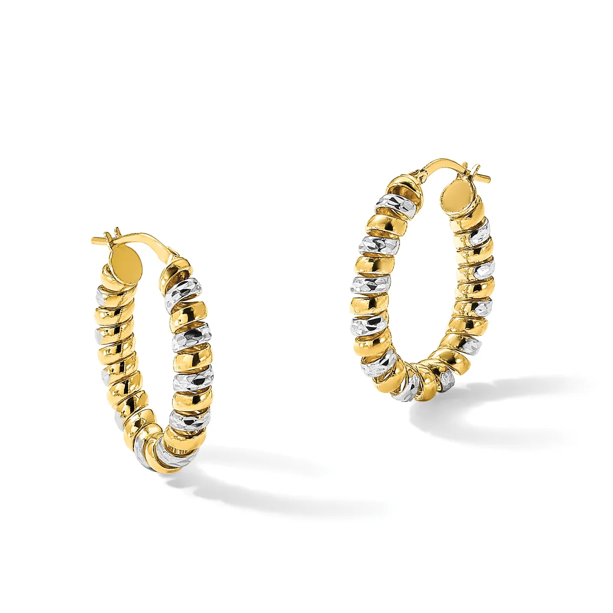 A pair of two-tone gold hoop earrings with alternating smooth and textured segments in yellow and white gold, displayed against a white background.