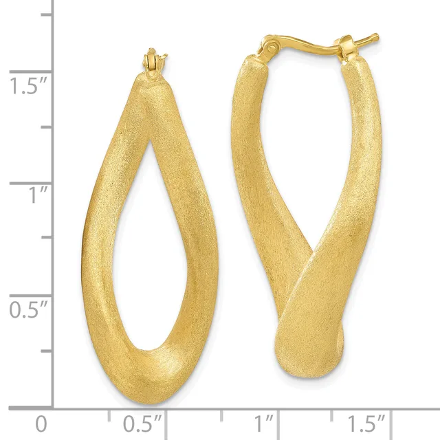 A pair of gold hoop earrings with a brushed finish and curved, tapered design, shown next to a measurement scale indicating approximately 1.5 inches in length.