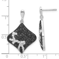 A pair of diamond-shaped drop earrings with black and white gemstones arranged in a curved pattern, shown next to a measurement ruler.