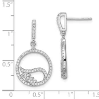 Silver dangle earrings featuring circular frames with diamond accents and curved internal wave designs, shown at actual size on a measurement ruler.