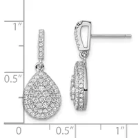A pair of diamond teardrop dangle earrings with pave-set stones on white metal posts, displayed next to a ruler showing approximately one inch in length.