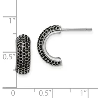 A pair of black gemstone-studded curved hoop earrings with a polished silver finish, displayed against a measurement scale showing approximately one inch in length.