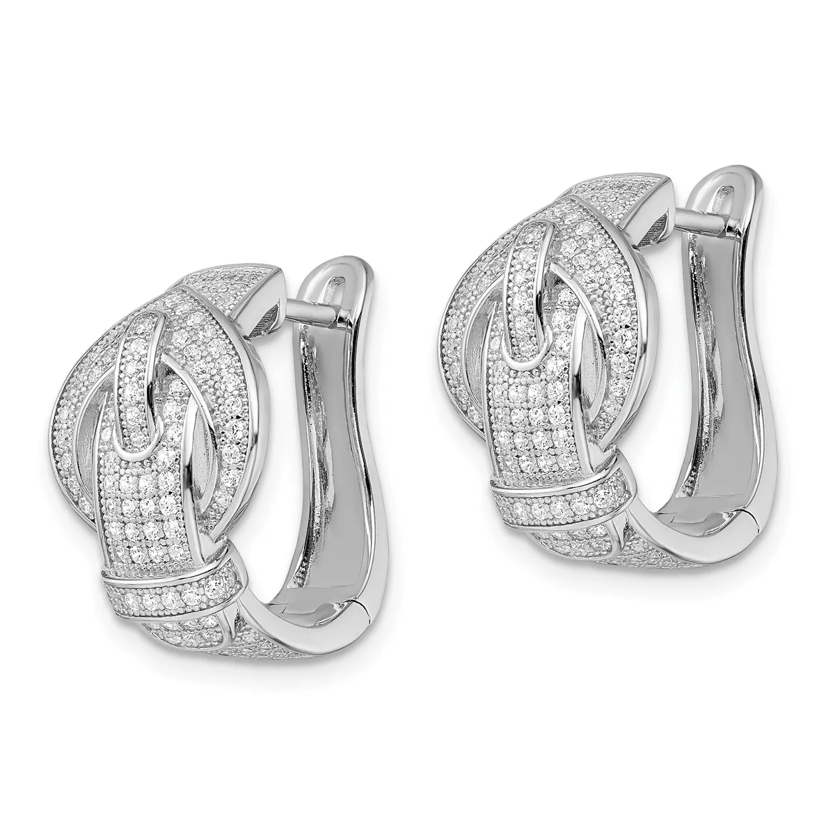 A pair of white metal huggie earrings with pave-set diamonds covering the surface in a curved, layered design, shown from front and back views.